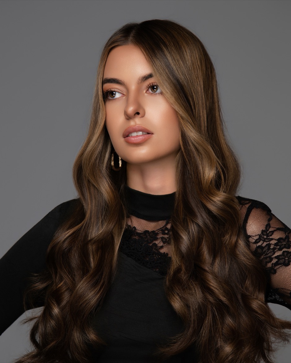 Model with long layered hair, front view, in the studio after a cut